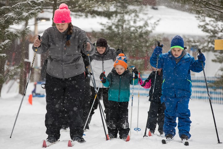family skiing with winter season pass