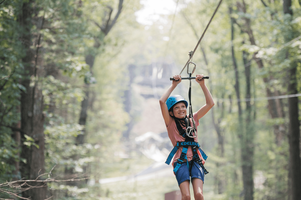 Girl on summer adventure on zip line