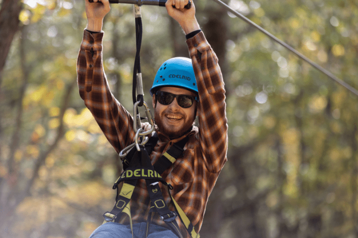 male with sunglasses on summer zip line adventure