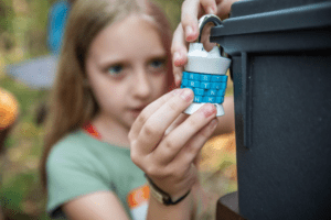 girl opening a combination lock for summer adventure game