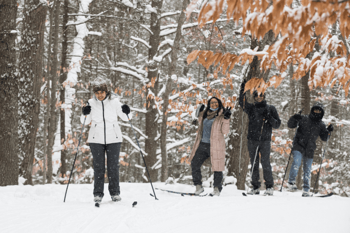 Two women cross country skiing and smiling