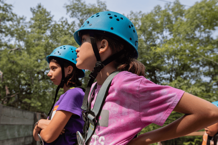 two girls getting climbing lessons