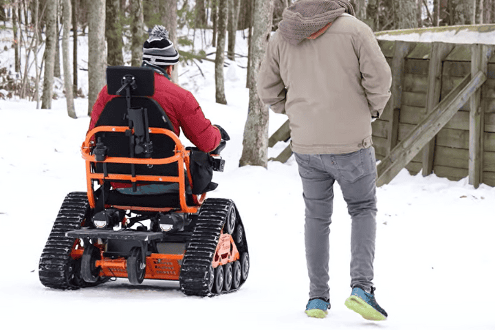 man operating an Action Track chair in the snow